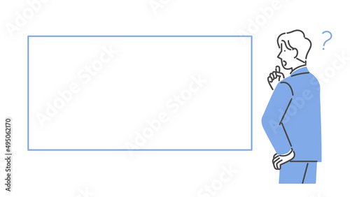 ホワイトボードを見て疑問に思う男性