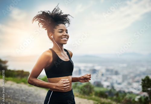 Run with all your heart. Shot of a sporty young woman running outdoors.
