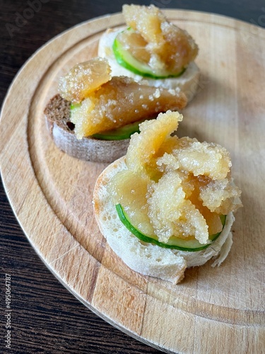 close-up of light yellow herring caviar on a cucumber slice and a baguette. Homemade snacks. Source of vitamins and omega-3s. large vertical video.
