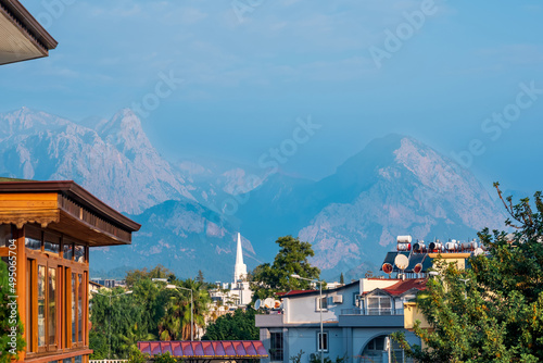 landscape with distant blue mountains behind city rooftops, Kemer, Antalya, Turkey
