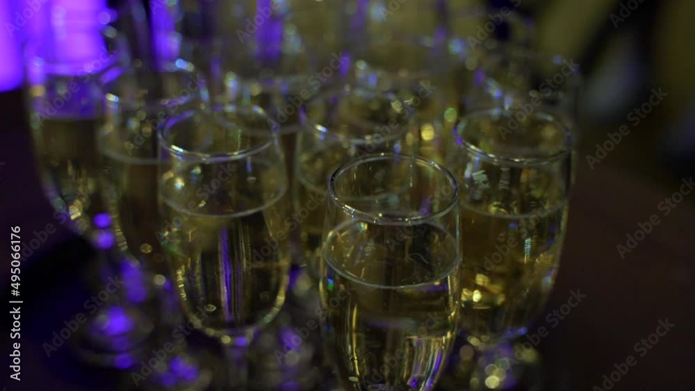Close-up of a glasses with champagne on the buffet table in the restaurant hall Close-up of a glasses with champagne on the buffet table in the restaurant hall
