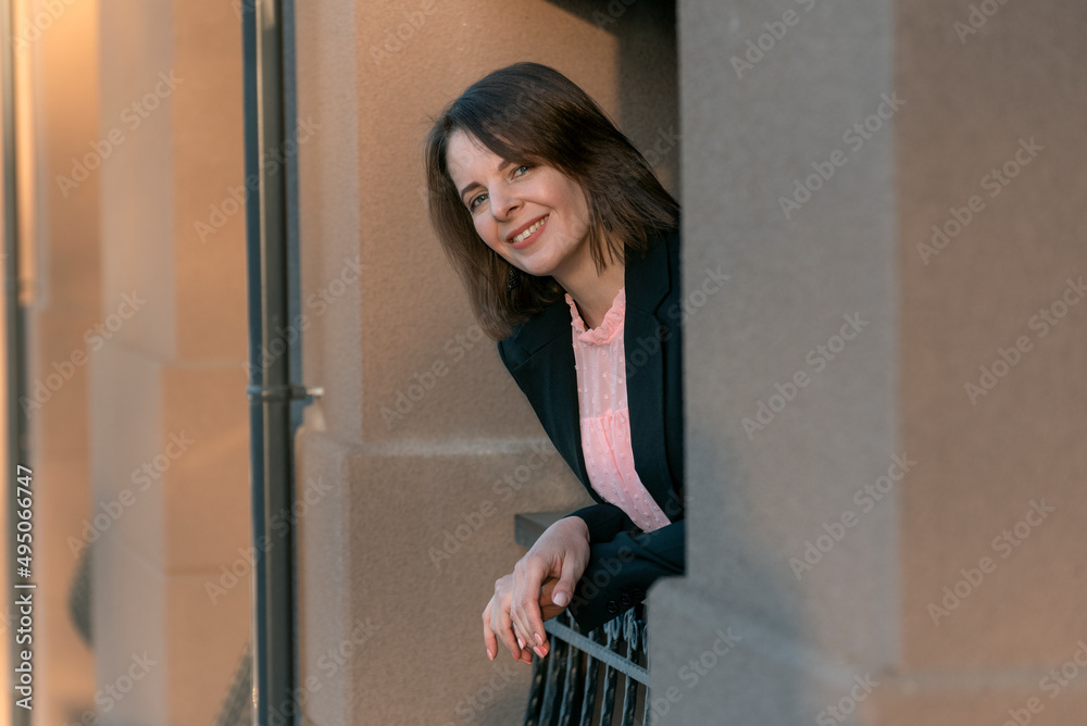 Smiling girl with bob haircut. Portrait of successful business woman on the balcony. Happy woman on break. Smiling girl with bob haircut. Portrait of successful business woman on the balcony. Happy woman on break.