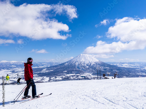 Skier with a snowy volcano (Niseko, Hokkaido, Japan) photo