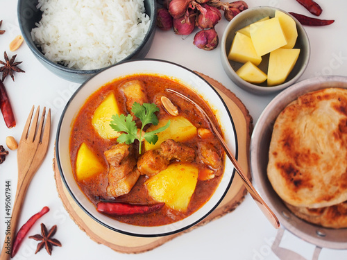 Belly pork massaman curry serve with roti and rice photo