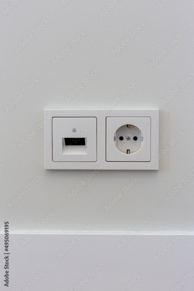 Double electrical socket on a white wall in the room Double electrical socket on a white wall in the room