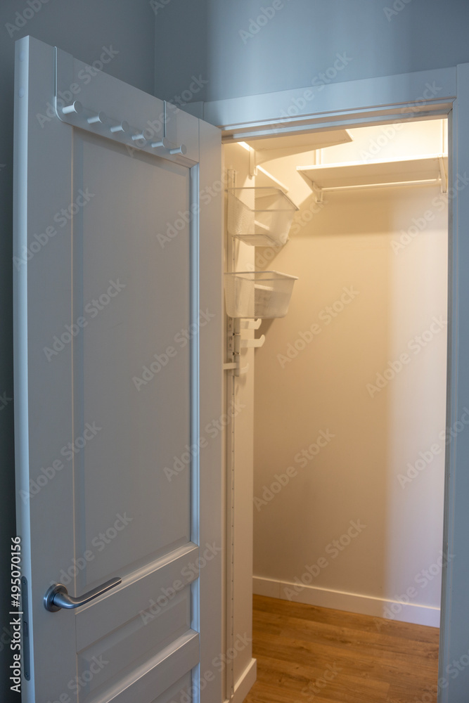Open door to an empty light closet Open door to an empty light closet