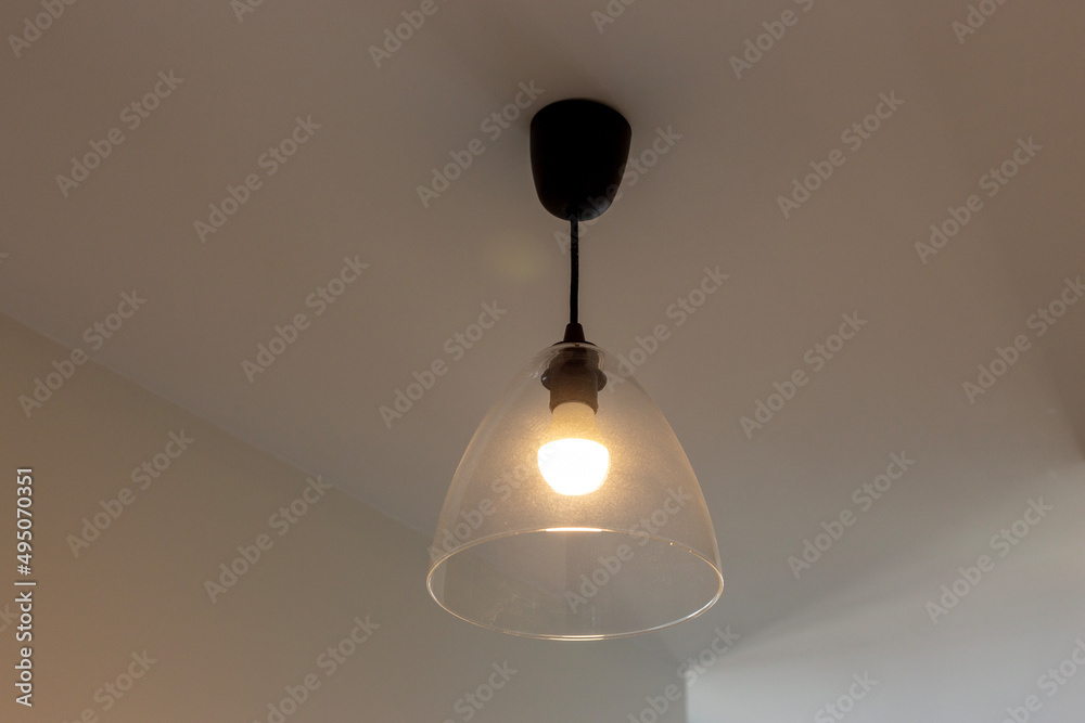 Lamp with glass shade on the ceiling in the room Lamp with glass shade on the ceiling in the room