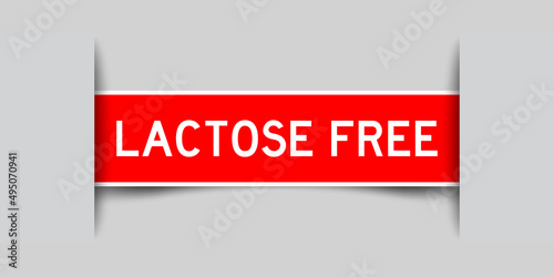 Inserted red color label sticker with word lactose free on gray background