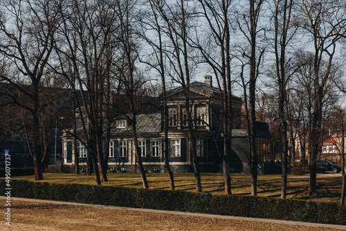 Old traditional wooden house in Riga village on sunny spring day, Riga, Latvi...