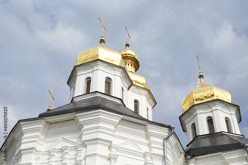 Gilded domes of an ancient Orthodox church against the sky. Catherine's Church is a functioning church in Chernihiv
