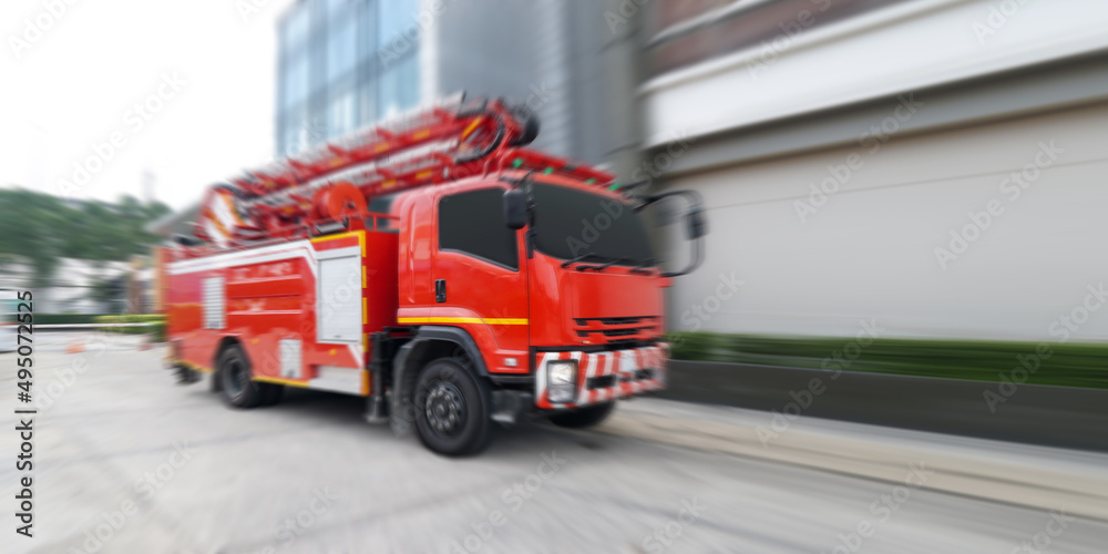 Red fire rescue car driving fast on a road. Red fire rescue car driving fast on a road.