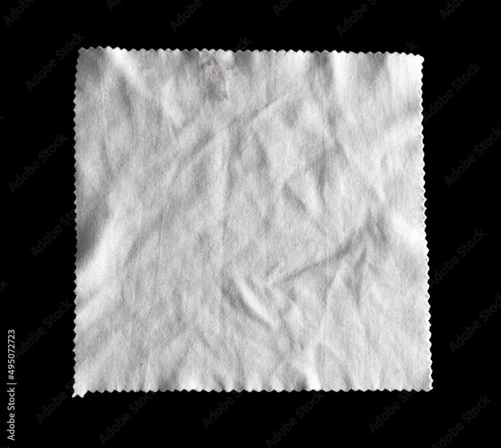 Fototapeta premium White crumpled napkin isolated on black
