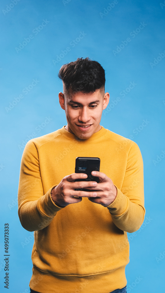 Man using his mobile phone while standing over an isolated background. Man using his mobile phone while standing over an isolated background.