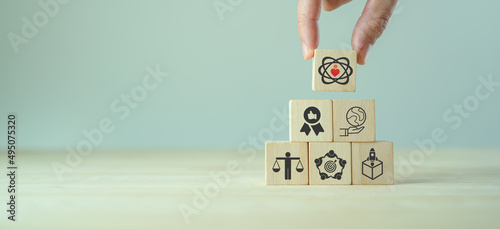Core values,corporate values concept.  Company culture and strategy related to business and customer relationships, company growth. Principles guide company\'s action. Core values icon on wood blocks.