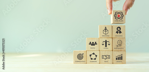 Core values,corporate values concept.  Company culture and strategy related to business and customer relationship, growth. Principles guide company\'s action. Stack wooden cubes with core values icons.