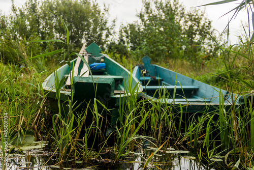 old wooden boat on the lake photo