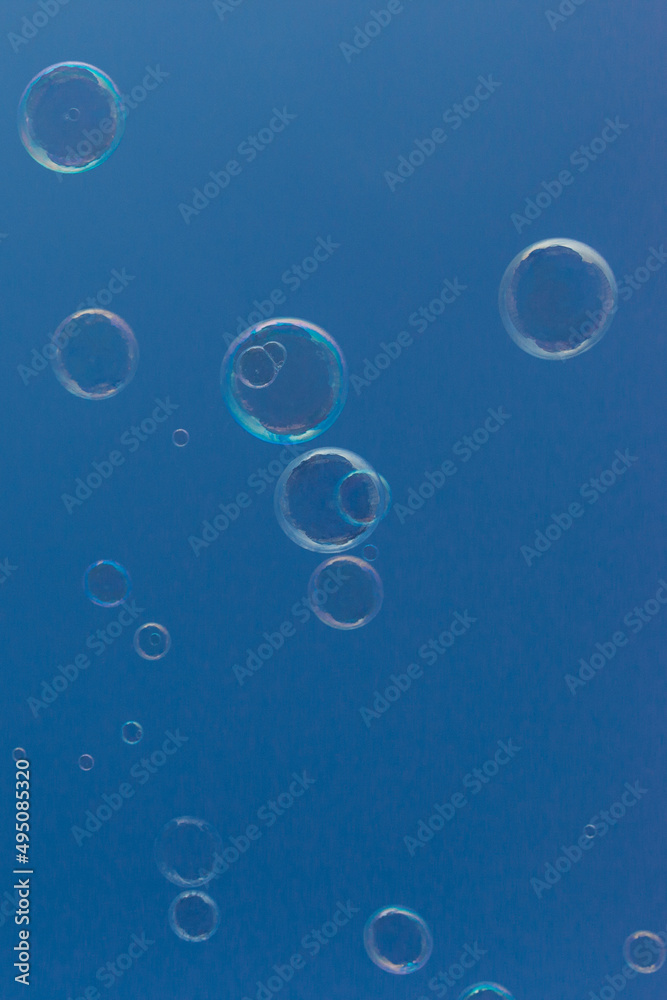 Natural Soap Bubbles Floating on Blue Background