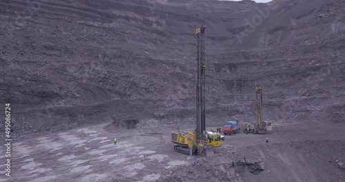 Aerial view of blasting holes coal mining area, open-pit mine, quarrying.  Drone shooting preparing for blasting open cast mine mining of coal, overall plan.