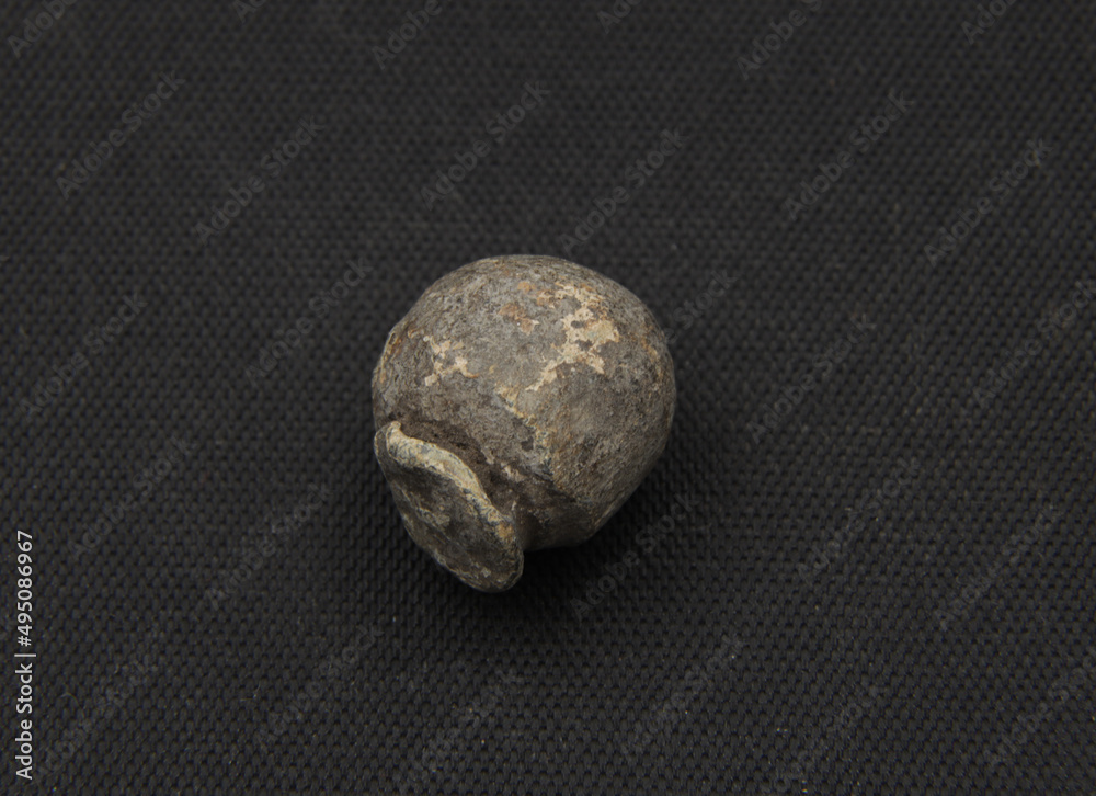 Fototapeta premium Medieval lead bullet on black background