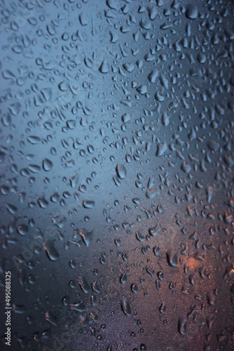 raindrops on glass in cold weather in the evening