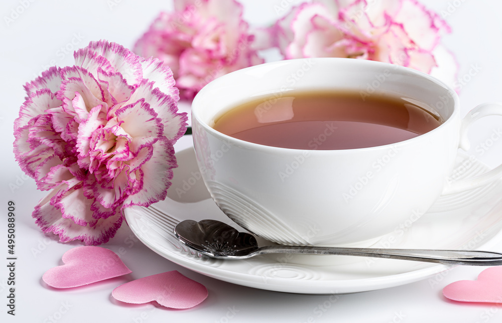 Fototapeta premium Cup of tea and pink carnations