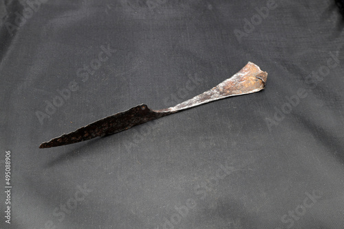 Antique rusty knife on black background