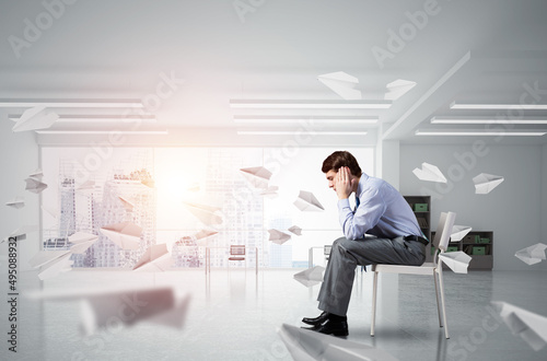 young businessman on chair in office