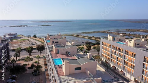 Aerial view of the urban area of portugal in the south of houses with modern infrastructure swimming pools overlooking the sea. Southern city of Portugal Olhao.