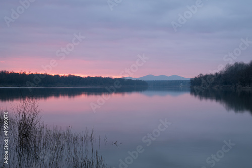 Calm dusk over Sava river with fading light with mountain in haze - beautiful natural landscape