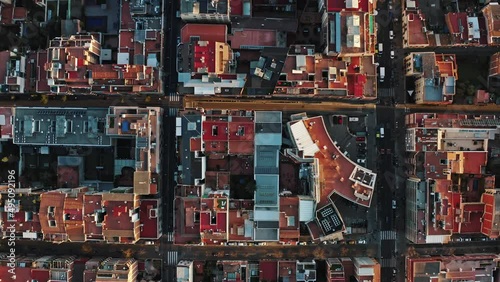 Top zoom out view from drone on european business city blocks. Modern buildings having geometric shapes are grouped in districts separated by roads or streets crossed at right angles. Barselona, Spain photo