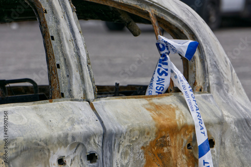Burned down car with swedish police tape