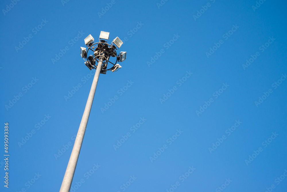 Tall outdoor spotlight stadium in day time with clear blue sky with copy space. Tall outdoor spotlight stadium in day time with clear blue sky with copy space.
