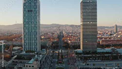 Aerial wide angle view from drone of the highest two skyscrapers in Barcelona, Hotel Arts and Torre Mapfre buildings. Panorama of urban residential, business and historic districts is on background photo