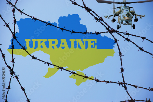 War in Ukraine, barbed wire, Ukrainian flag, attack on Ukraine by Russian helicopters. Threat to Europe