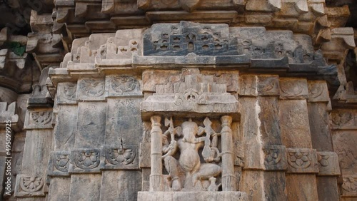 Closeup video of Lord Ganesha sculpture carved on  wall of Jagdish temple at Udaipur, Rajasthan, India. Indian architecture and ancient Hindu temple wall carving background. photo