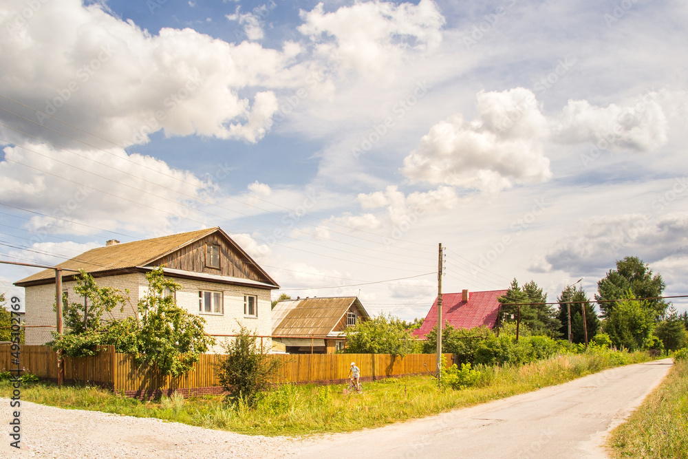 Large brick house at the intersection of streets  at summer