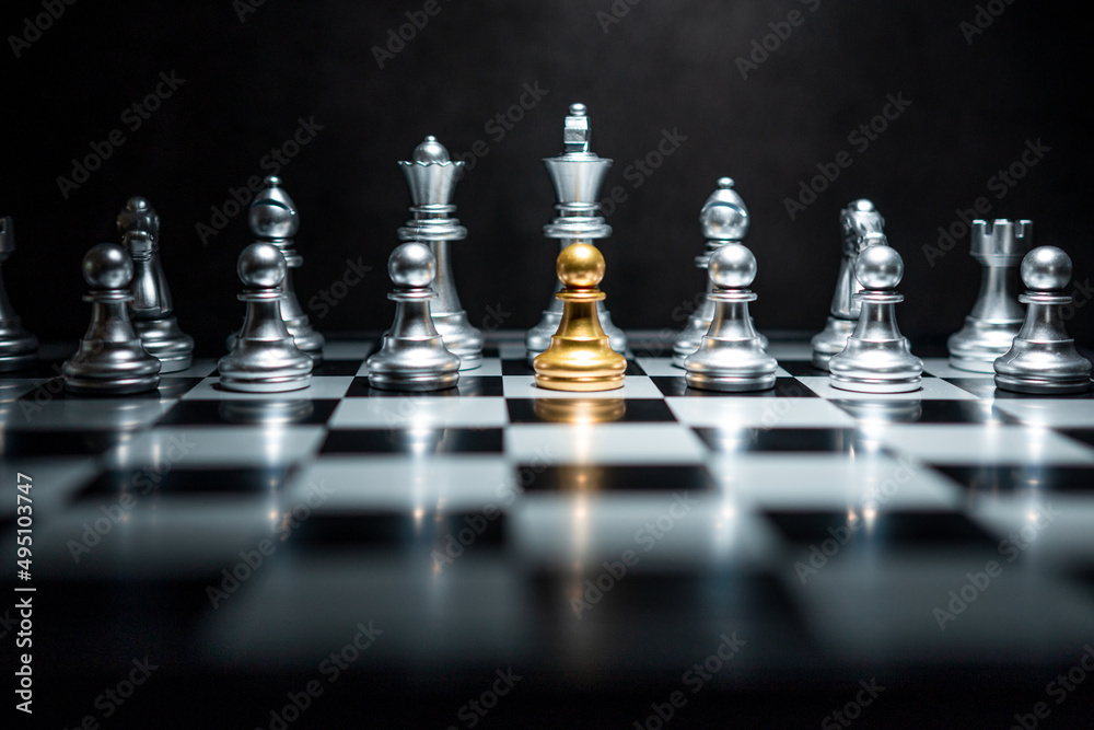 Gold chess piece surrounded by silver chess pieces, competition and teamwork concept. Gold chess piece surrounded by silver chess pieces, competition and teamwork concept.