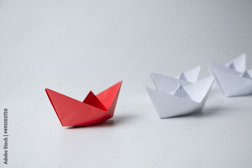 Leadership and teamwork concept, Red paper ship leading among white