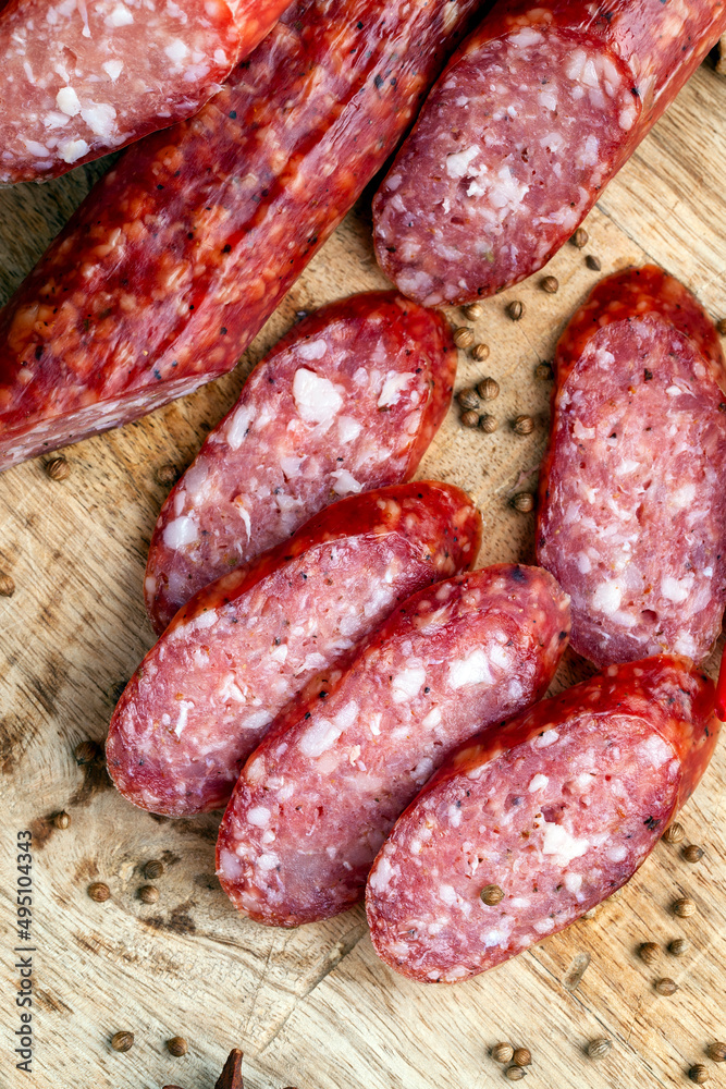 sliced pieces of sausage from meat are lying on a cutting board sliced pieces of sausage from meat are lying on a cutting board