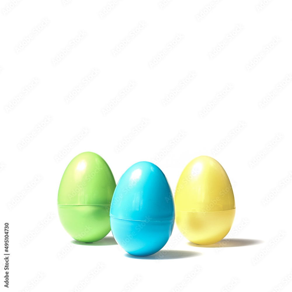 Three Colored Plastic Easter Eggs on White Background Green Blue Yellow Spring in April Three Colored Plastic Easter Eggs on White Background Green Blue Yellow Spring in April