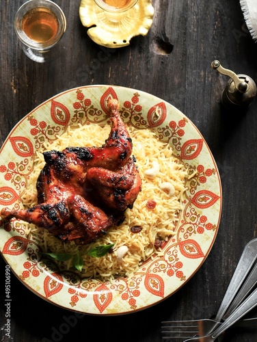 Kashmiri Pulao Made of Long Grain Basmati Rice Cooked with Spices and Flavored with Saffron and Raisin, On Wooden Background photo