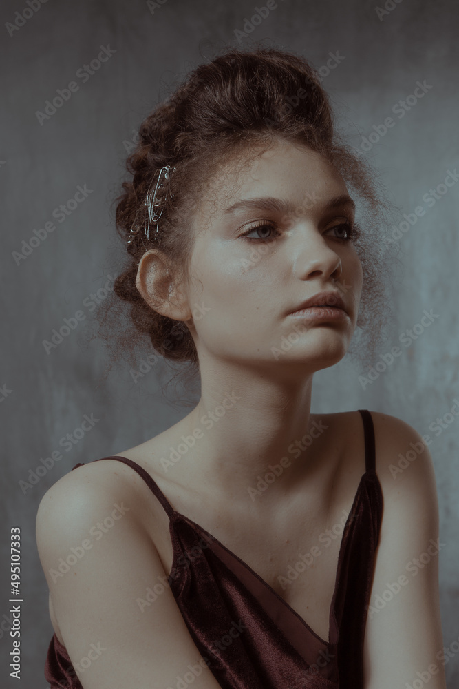Art portrait in retro style of a beautiful girl with hair and makeup