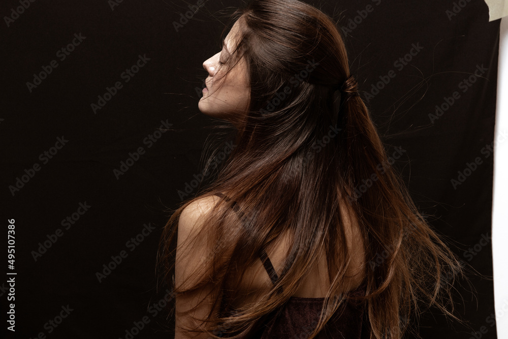 Beauty portrait of a beautiful girl with makeup and long hair