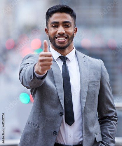 Ive got it covered from here. Shot of a handsome young businessman standing alone and showing a thumbs up.