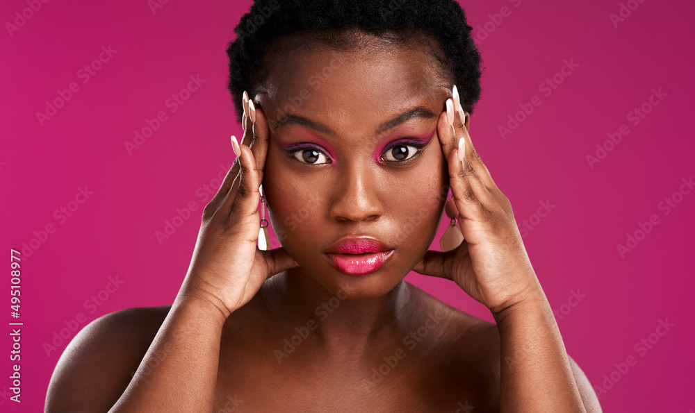 Fototapeta premium Once Im focused ,I go for what I want. Studio shot of a beautiful young woman posing against a pink background.