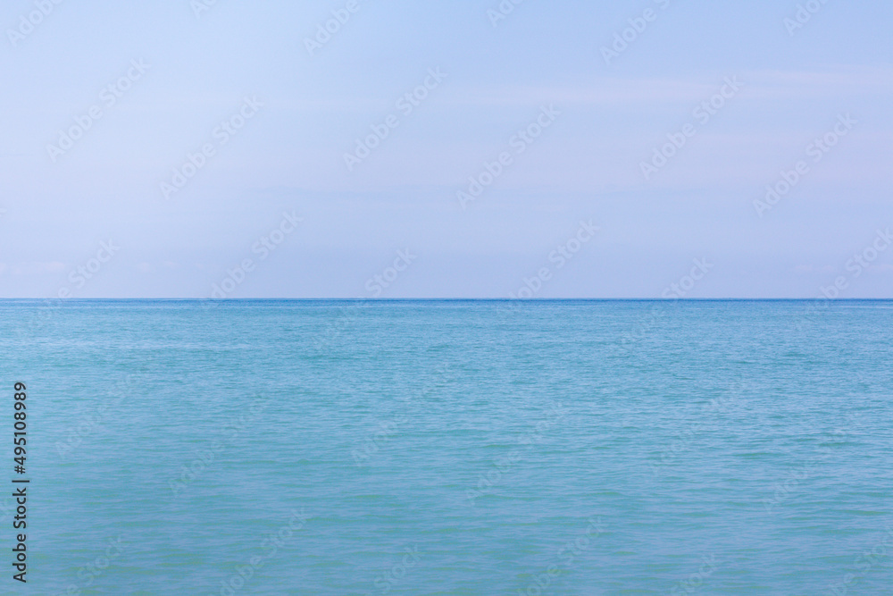 Blue calm sea and blue sky horizontal background for copy space. 