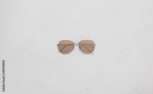 Aviator sunglasses (aviators) on a grey background. Copy space, flat lay. 