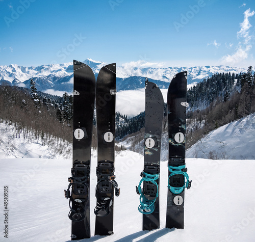 Splitboards in snow at winter mountains background. Sport equipment for ski touring