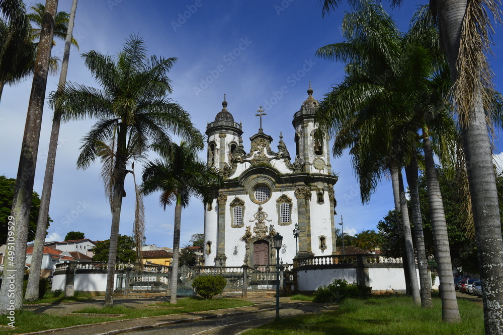 Vista dos coqueiros com igreja histórica ao fundo