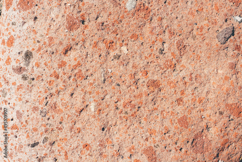 Natural stone textured horizontal background in red and orange colors. 